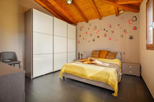 a bedroom with a bed and a wall with a clock at Casa a schiera Budoni in Budoni