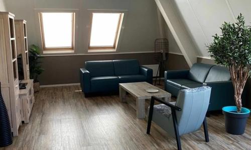 a living room with a couch and a coffee table at Appartement Zilt in Hollum