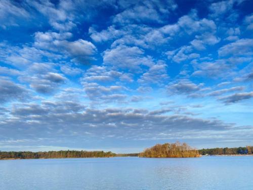 a large body of water with a blue sky with clouds at de Merel in Vught