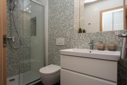 a bathroom with a toilet and a sink and a shower at Luxury rooms Beach Mediteran in Podstrana