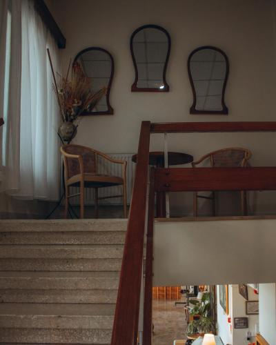 a room with stairs and a table and chairs at Kallithea INN in Platres
