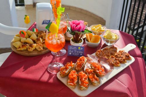 a table with shrimp and appetizers on a red table at Le Twins -Bed and Breakfast in Tropea