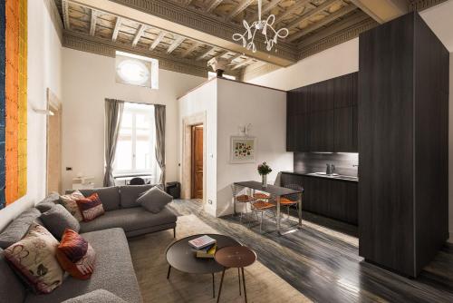 a living room with a couch and a table at Palazzo Delle Pietre - Luxury Apartments in Rome