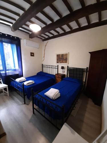 a bedroom with two blue beds in a room at Casale Valentini in Fermo