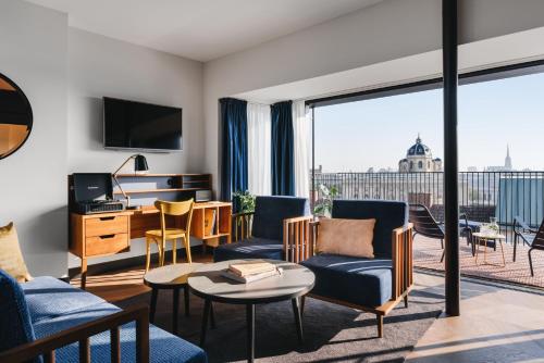 a living room with a view of the city at Hotel Gilbert in Vienna