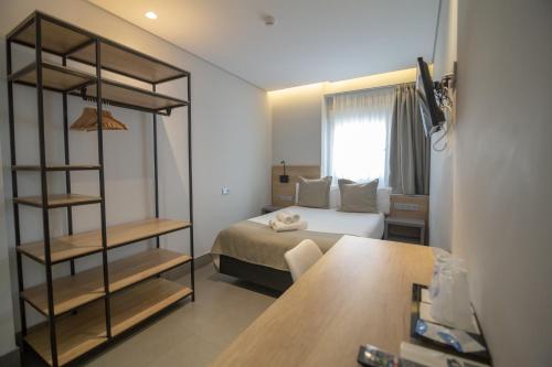 a hotel room with a bed and a desk at Hotel La Milagrosa in Alicante