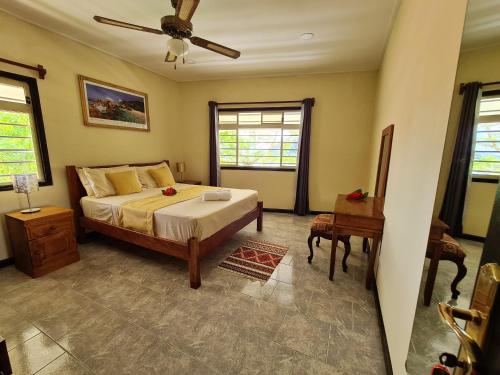 1 dormitorio con 1 cama y ventilador de techo en 3 bedrooms house with sea view enclosed garden and wifi at Souvenir, en Misere