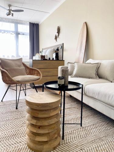 a living room with a couch and a table and chairs at Aqua Hotel in Konstanz