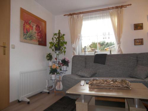 una sala de estar con un sofá y una mesa en Bungalow Vincent mit Terrasse, Grill & WLAN, en Zempin