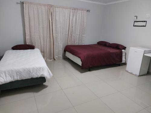 a bedroom with two beds and a window at Special Inn Bed and Breakfast in Windhoek
