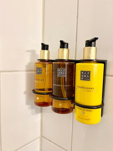 a group of four bottles on a wall at Aqua Hotel in Konstanz