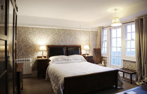 a bedroom with a large bed and a wall of wallpaper at Walpole Bay Hotel in Margate