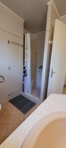 a bathroom with a shower with a shower curtain at "à casita" villa 8 personnes avec piscine in Moriani Plage