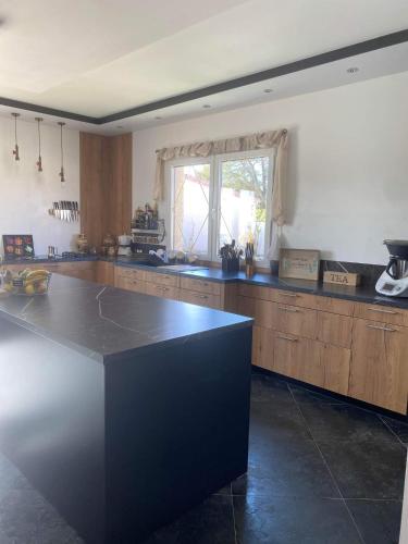 a large kitchen with a large island in the middle at il piccolo castello in Méjannes-lès-Alès