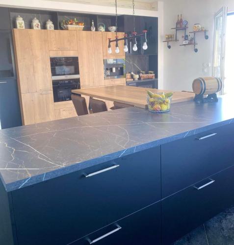 a kitchen with a counter with a blue counter top at il piccolo castello in Méjannes-lès-Alès