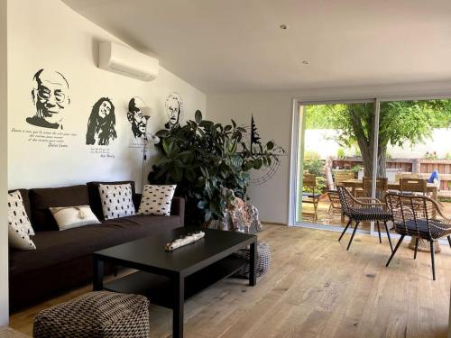 een woonkamer met een bank en een tafel bij Une Oasis au Pays de Cézanne in Aix-en-Provence