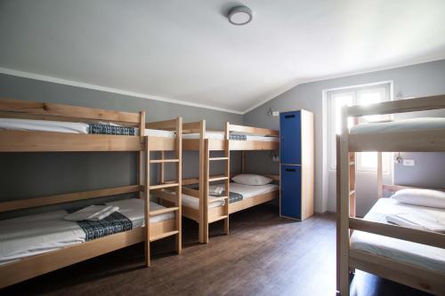 a room with several bunk beds in a room at Hostel Adriatic Piran in Piran