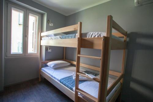 two bunk beds in a room with a window at Hostel Adriatic Piran in Piran