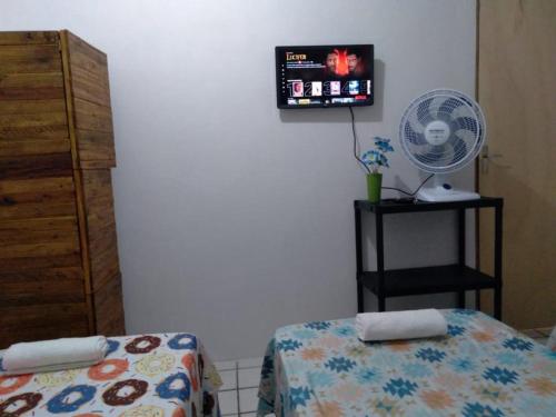 A television and/or entertainment centre at Hostel Pininha