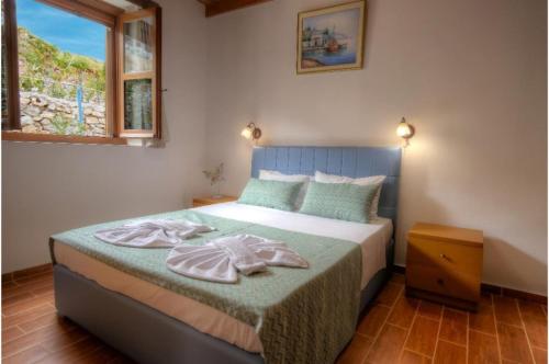 a bedroom with a bed with two towels on it at Stone Villa II in Petres in Petres