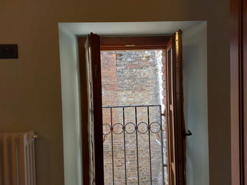 a door leading to a window with a gate at LA MONTADARIA in Zavattarello