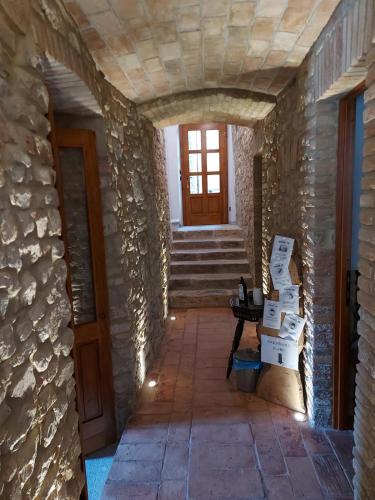 a hallway of a house with a door and stairs at LA MONTADARIA in Zavattarello