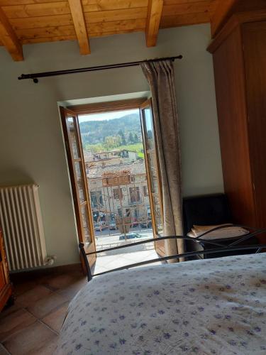 a bedroom with a large window with a view at LA MONTADARIA in Zavattarello