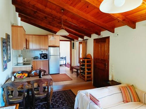 a kitchen and a living room with a table at Casa di Maria in Rethymno