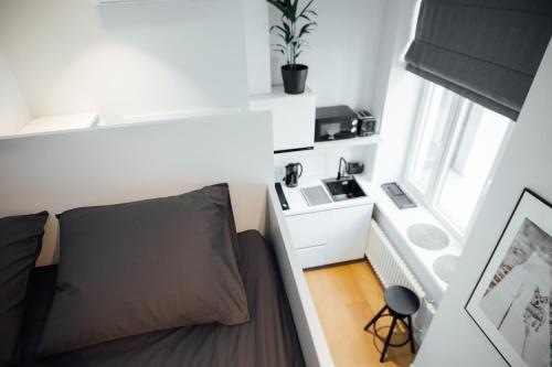 een kleine kamer met een bed en een raam bij NEW! Modern Loft near Park with A/C in Rīga