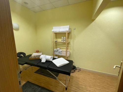a exam room with a table in a room at Parkhotel Waldschlösschen in Annaberg-Buchholz