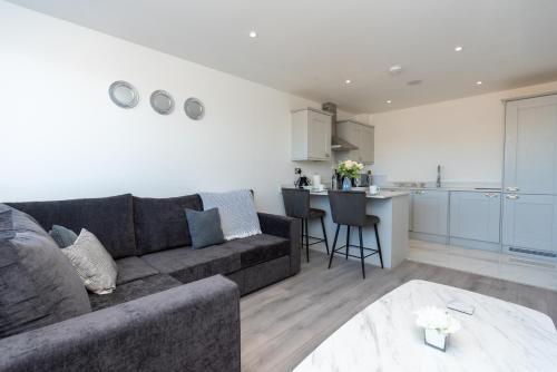 a living room with a couch and a kitchen at Modern Apartments in Kings Lynn with Free Wi-Fi in King's Lynn