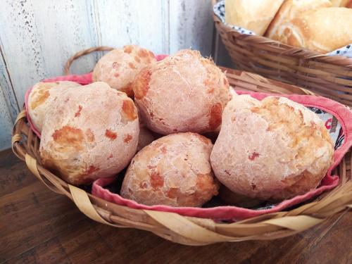 a basket filled with balls of bread on a table at Pousada do Duque in Lambari