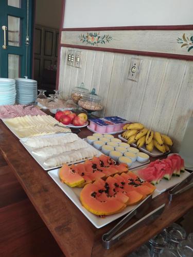 a table topped with lots of different types of food at Pousada do Duque in Lambari