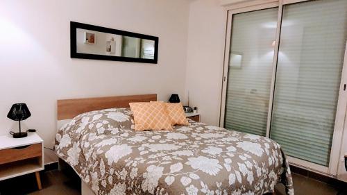 a bedroom with a bed and a mirror on the wall at appartement résidence La Plage 4 **** in La Londe-les-Maures