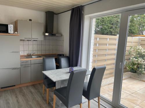 a kitchen and dining room with a table and chairs at Familie Decker-Behrends in Upleward