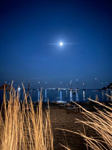 a view of a beach at night with a moon at Villa Panorama in Ligia