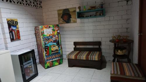 a corner of a room with a refrigerator and a table at Habitaciones cerca del aeropuerto in Bogotá