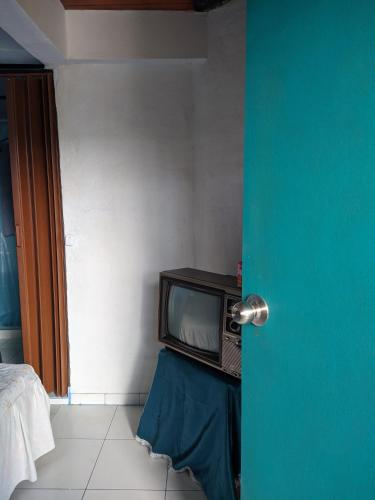 a television sitting on a table in a room at Casa de Campo La Prosperidad in Bobadilla