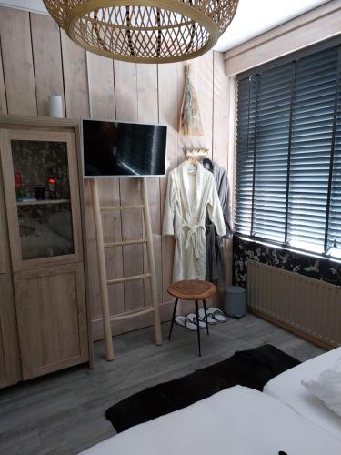 a bedroom with a mannequin and a tv in a room at Sweetlake in Zoetermeer
