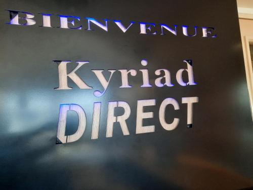a sign that reads istg direct on a wall at Kyriad Direct Caen Nord Memorial in Caen
