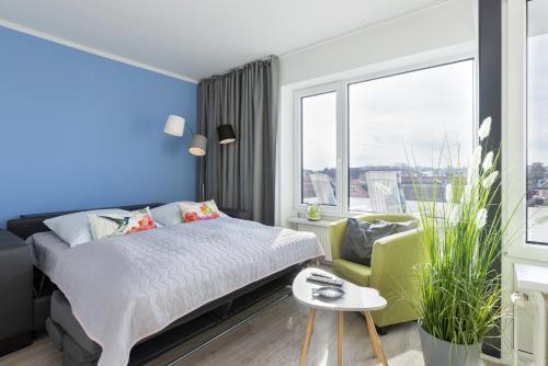 a bedroom with a bed and a large window at Haus Seebad Aussicht in Grömitz