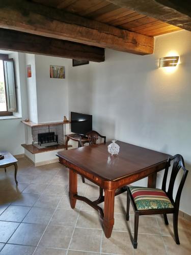 a living room with a wooden table and chairs at Dimora Storica Torre degli Arduini, San Giacomo, Spoleto in San Giacomo