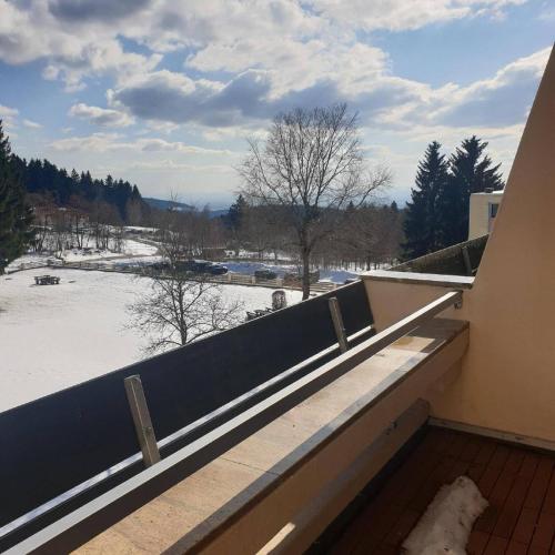 a balcony with a view of a snow covered field at Ferienwohnung Mia in Sankt Englmar