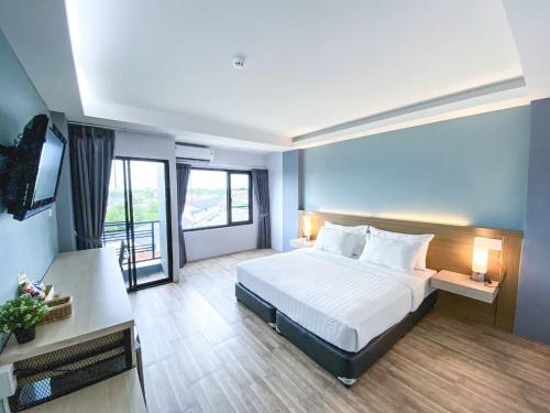 a hotel room with a bed and a television at MtriO Hotel Korat in Nakhon Ratchasima