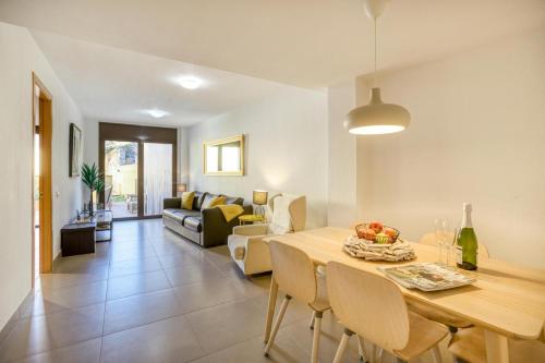 a dining room and living room with a table and chairs at Ground floor apartment in Centre of Torroella De Montgri in Torroella de Montgrí