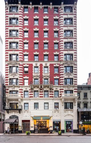 a large red building on a city street at Radio City Apartments in New York