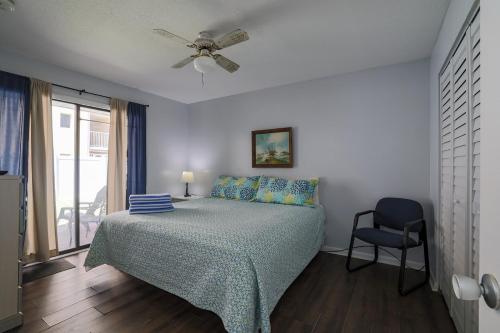 a bedroom with a bed and a ceiling fan at Coastal Waters in New Smyrna Beach