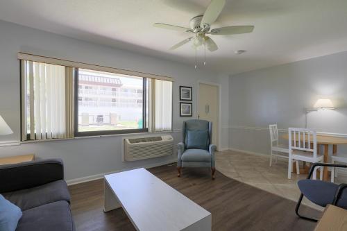 a living room with a couch and a window at Coastal Waters in New Smyrna Beach