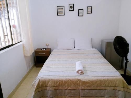 a bedroom with a bed with a roll of paper on it at Habitación en la playa in Tumbes