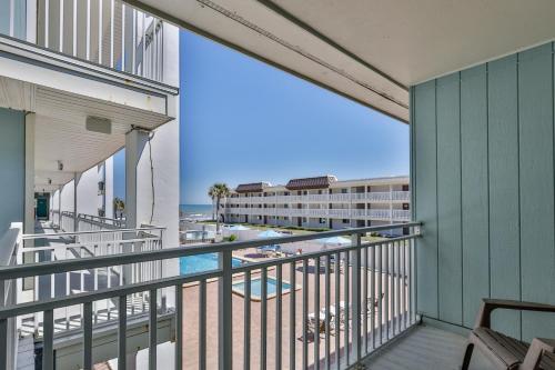 a balcony with a view of the beach and the ocean at Coastal Waters in New Smyrna Beach